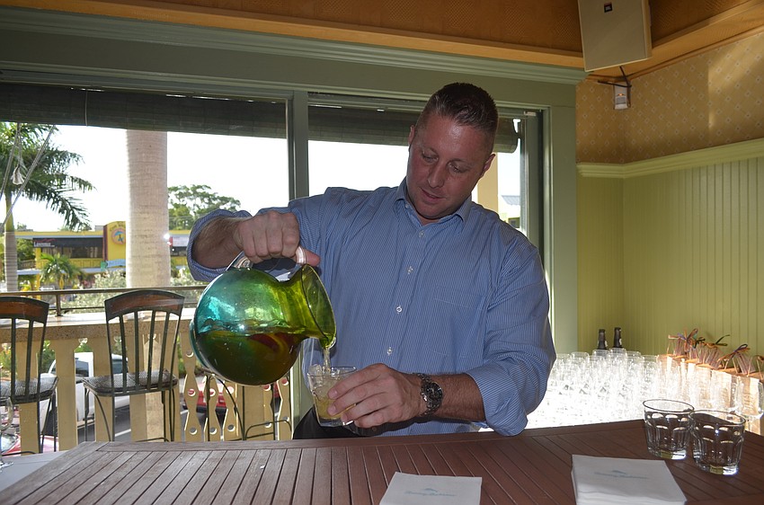 Zach Raymond, of Republic National Distributing Company, pours some peach sangria.