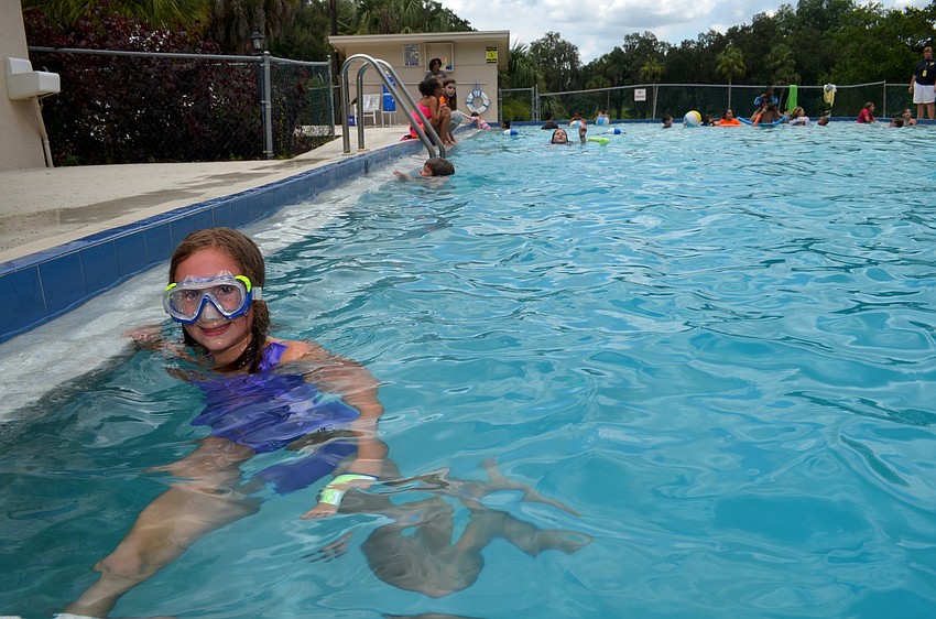 Violet Reinhardt enjoys a cool swim in the pool on a hot day.