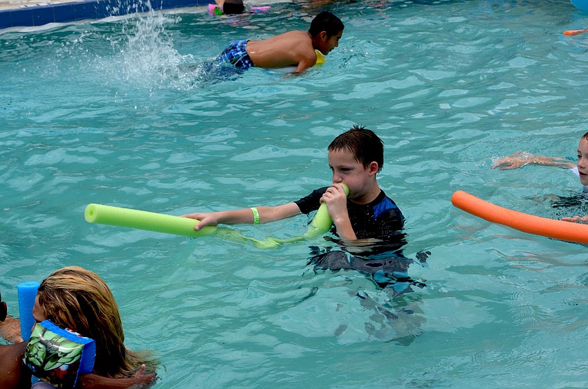 Alvin Johnson launches a water attack on nearby friends.