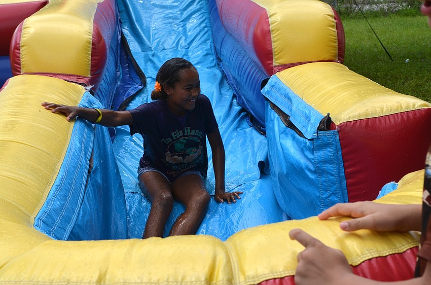 Asia Rosado cheers after sliding down the biggest water slide at camp.
