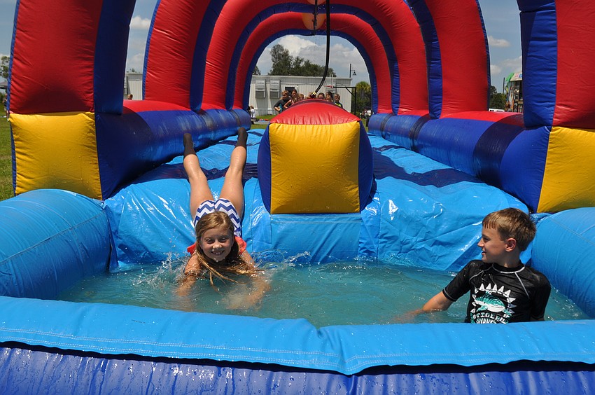 Molly Patton, 8, and Bobby Nelson, 9, race through the slip and slide.