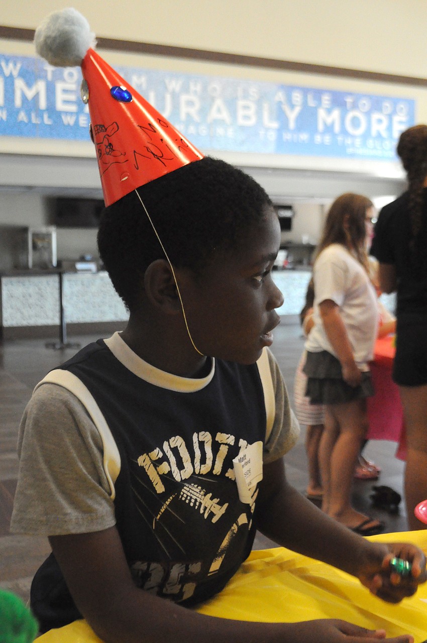 Matt Vanderford, 8, finished his carnival hat.