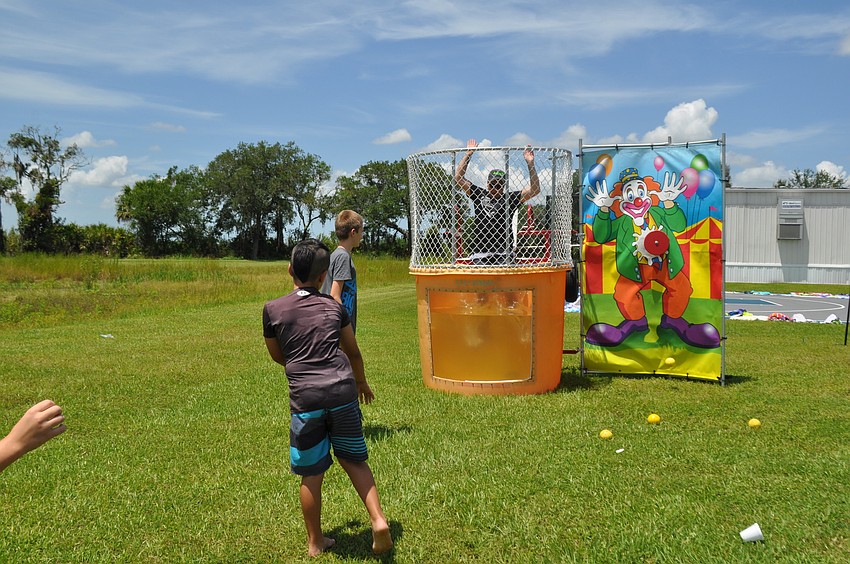 Eddie Zaun, 8, dunks Youth Pastor Luke Graham into the dunk tank.
