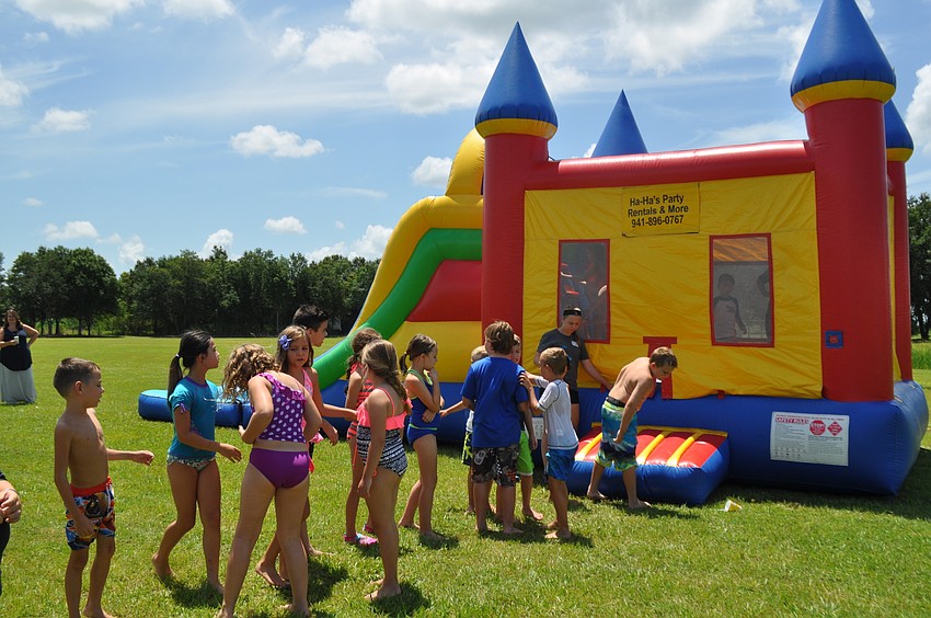 Vacation Bible schoolers line up for the bounce and slide house.