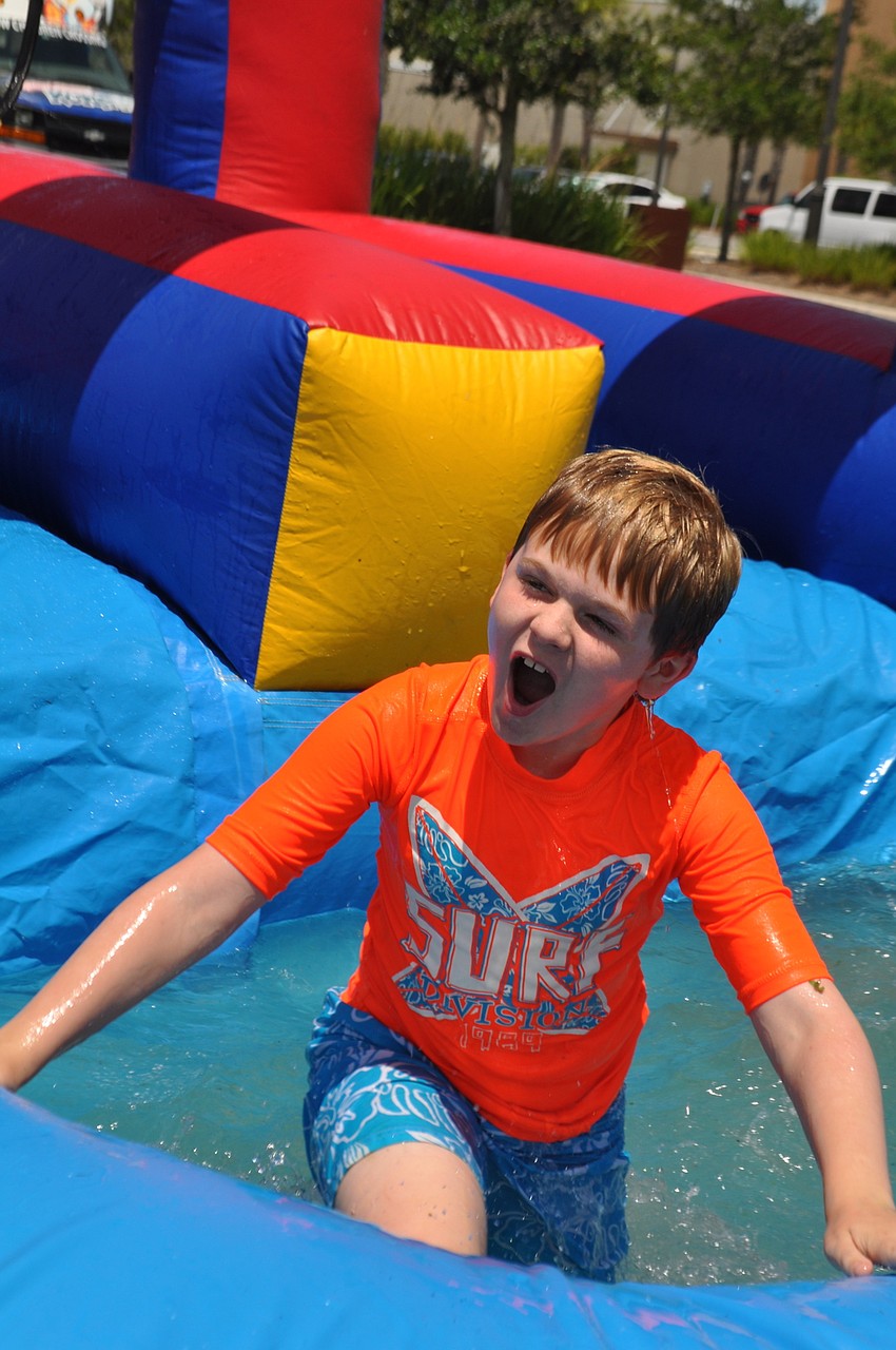 Jonathan Robinson, 9, crashes into the slip and slide pool.