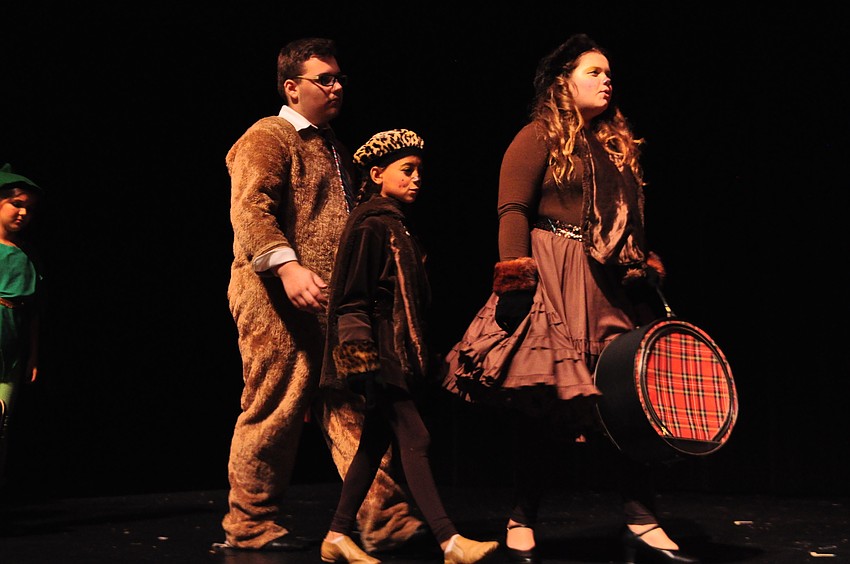 Brown bears Christian Malaga, Yaira Spears and Jordan Bollinger walk away, displaced from their home in the swamp.