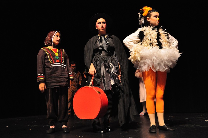 Storybook characters Isabela Mendez (Gingerbread Man), Melissa Silva (Wicked Witch) and Nicole Peterson (Duck) lament to Shrek about losing their home at the swamp.