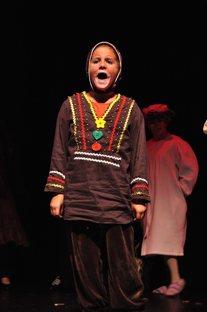 Isabela Mendez, as the Gingerbread Man, lights up the stage with a solo.