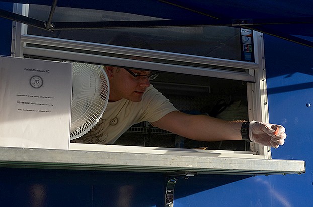 Chef Caleb Taylor collects tickets