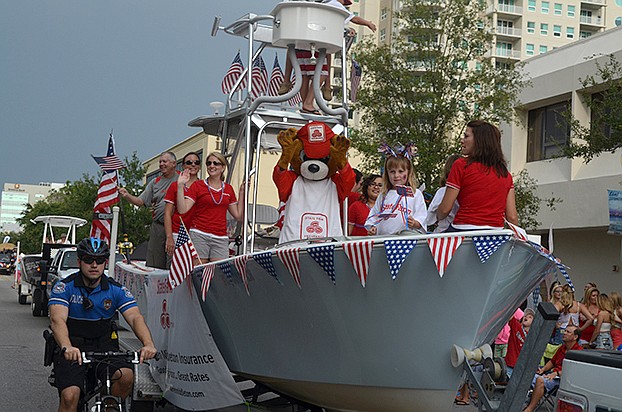 The Festival Parade of Boats makes its way down Main Street