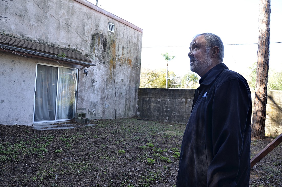 Charles Marchione walks around an abandoned home. The report said that complaint was that the home was unsafe and needed to be demolished, but he said it wasnâ€™t in bad shape.