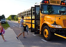 Ciarra Buff, a sixth-grader, and Joseph Peery, an eighth-grader,  board the bus for their first day of classes at Martha B. King Middle School. Asked if he was excited for school to start, Peery said, "I'd rather be fishing."
