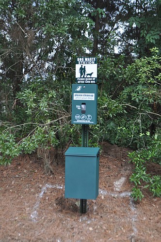 Dog waste stations like this one on Arnold Palmer Green in CDD 2 will soon be placed in 14 CDD1 locations.