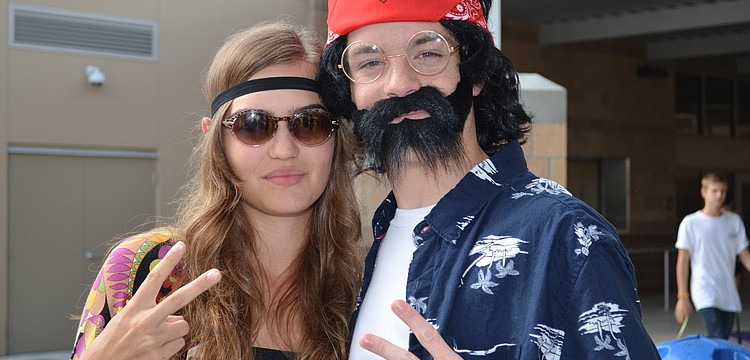 Grace Gerdes dressed as a groovy hippie and Robbie Hodgson dressed as Tommy Chong.