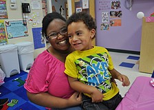 Michael Lawson sits with her son, Malachi, 3.