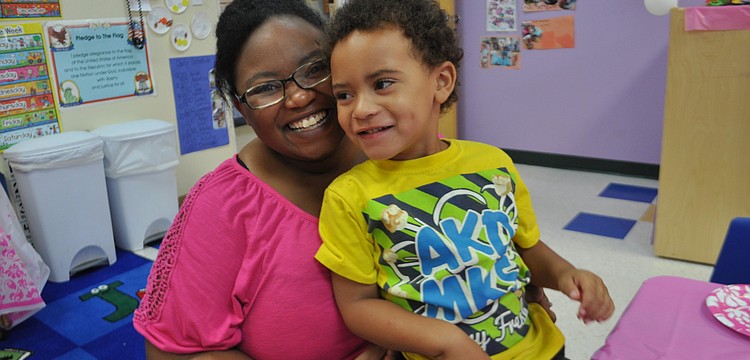 Michael Lawson sits with her son, Malachi, 3.