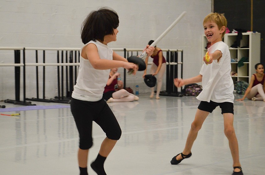 Four-year-old Adam Attari and seven-year-old Wilhelm Cockrell sword fight at a break in rehearsal