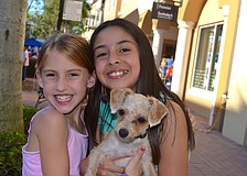 Rachel Small and Valeria Erazo say "cheese" beside their furry friend, Biscuit.
