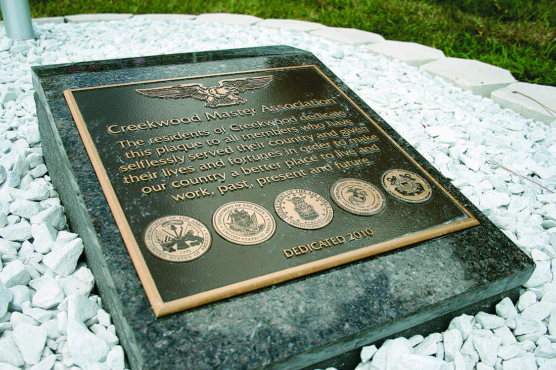 File photo The Creekwood Master Association dedicated its memorial, partially funded by the county's community enhancement program, during a Memorial Day celebration in 2010.