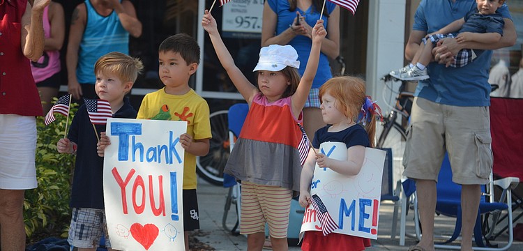 Declan Arnold, Zachery and Riley Ellis and Delaney Arnold cheer on the Sarasota Police Department.
