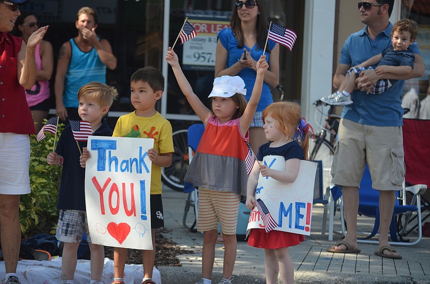 Declan Arnold, Zachery and Riley Ellis and Delaney Arnold cheer on the Sarasota Police Department.