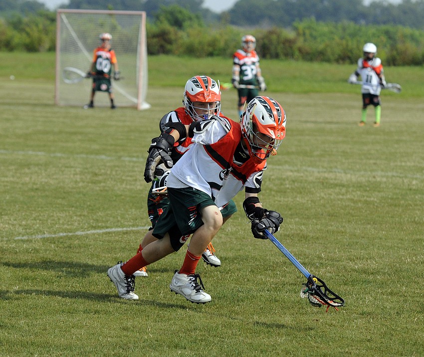 Caden Minniti scoops up the ball for the Monsters U11 white team.