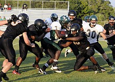Linebacker Jacari Dunbar and the Sailors defense wrap up St. Petersburg running back Jaquel Waller short of the goal line.