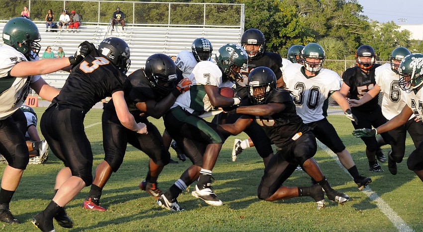 Linebacker Jacari Dunbar and the Sailors defense wrap up St. Petersburg running back Jaquel Waller short of the goal line.