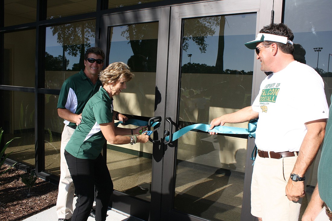 Courtesy photos St. Stephen's Head of School Dr. Jan Pullen cuts the ribbon at the grand opening of the new Falcon Field house.