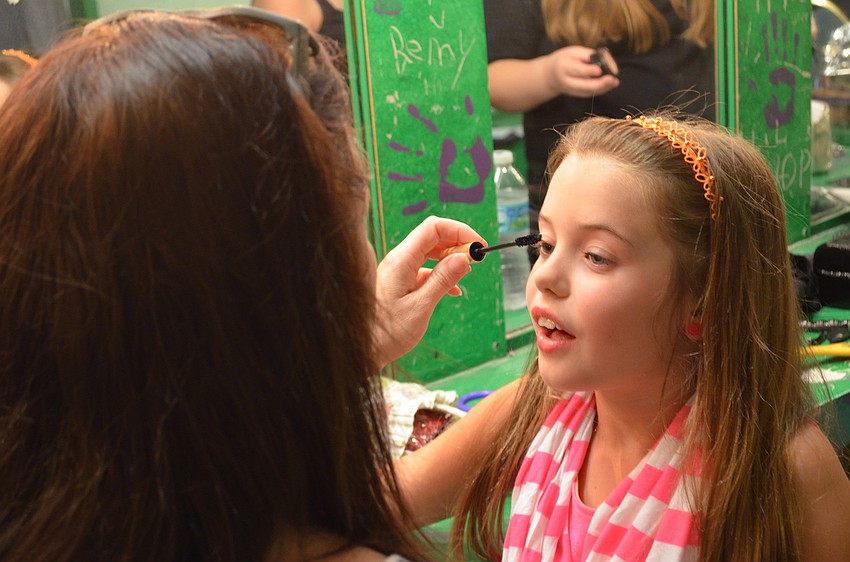 Julie Monkley helps her daughter Ashlynn Monkley, 8, get ready to perform what she learned in acting class and youth singing.