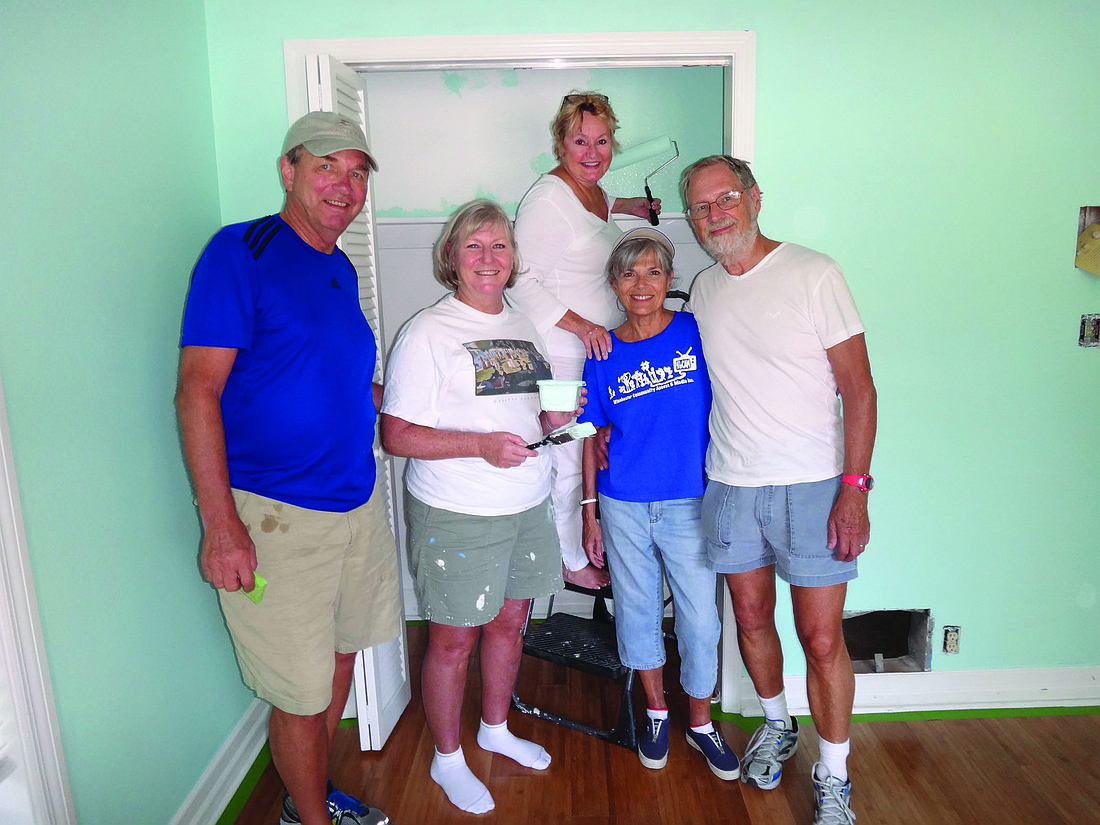 Rotary of Longboat Key charter members Jack Rozance, Carol Erker, Cynthia Crane, Sydelle Pittas and Philippe Koenig work on the room they adopted at Selah Freedom House. (Photo courtesy of Bob Erker)