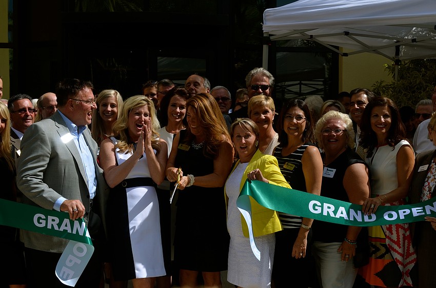 Annette Gueli and about 30 other participants helped cut the ribbon for the new facility.