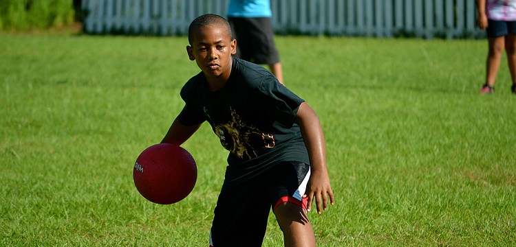 Ezra Mason pitches the ball to a faculty member.