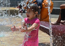 Sophia Colon, 1, cools off at the Children's Fountain Tuesday, June 10, at Bayfront Park. The Children's Fountain is open daily 10 a.m. to 7 p.m. through Labor Day, weather permitting.