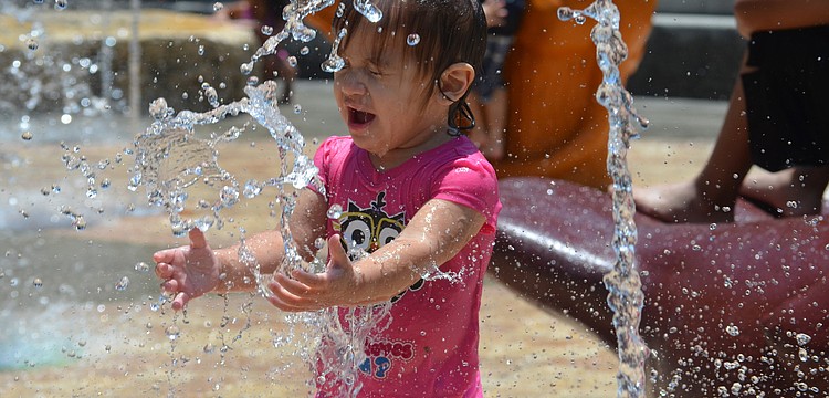 Sophia Colon, 1, cools off at the Children's Fountain Tuesday, June 10, at Bayfront Park. The Children's Fountain is open daily 10 a.m. to 7 p.m. through Labor Day, weather permitting.