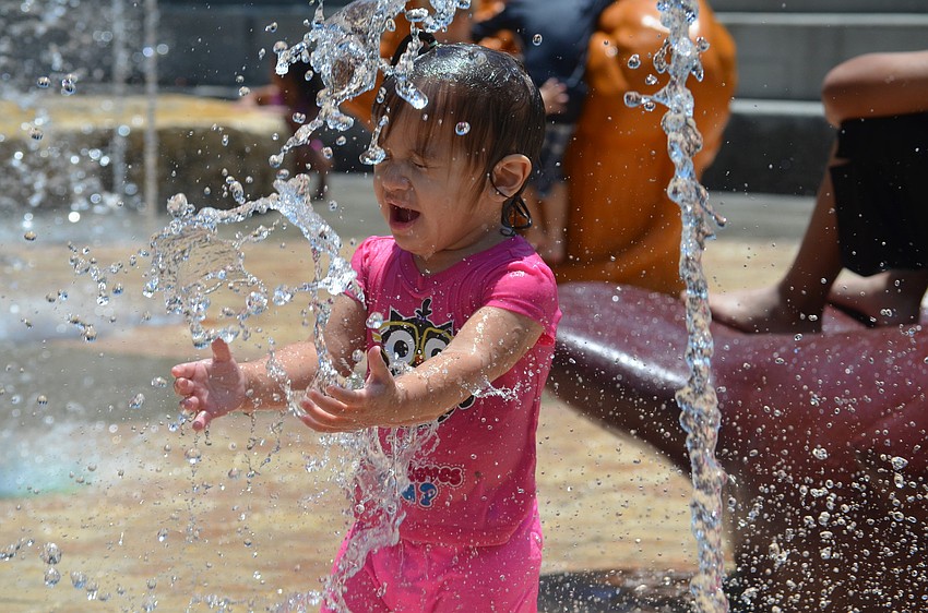 Sophia Colon, 1, cools off at the Children's Fountain Tuesday, June 10, at Bayfront Park. The Children's Fountain is open daily 10 a.m. to 7 p.m. through Labor Day, weather permitting.