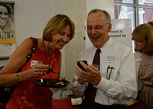 Ruth Anderson and Jeff Nickse look at photos.