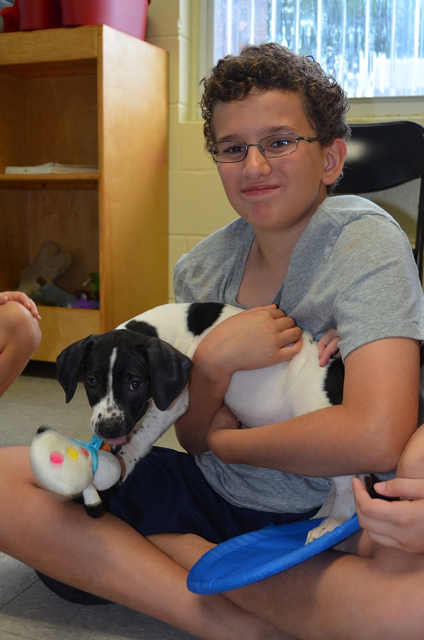 Connor Maag plays with the puppy.