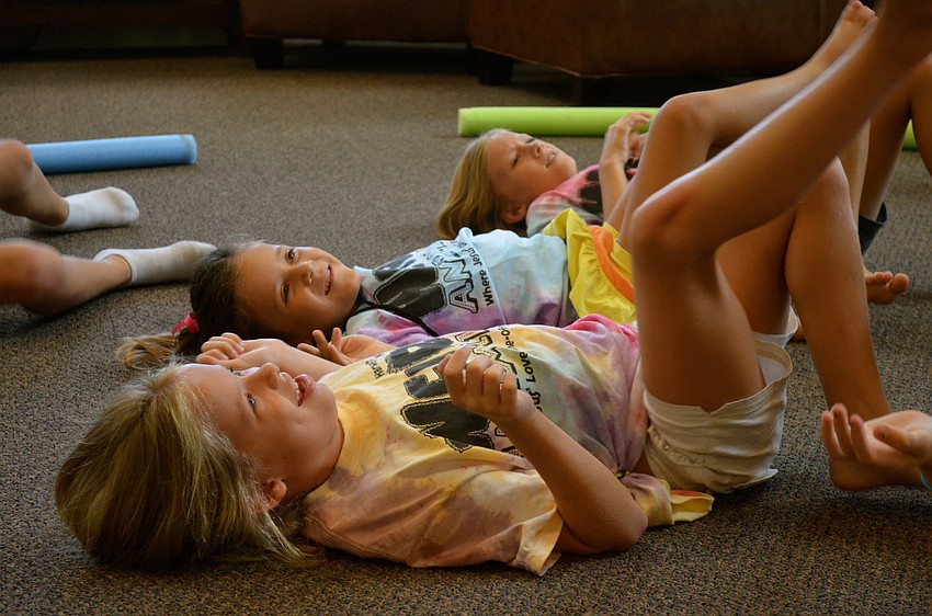 Seven-year-olds Madison Goda and Chiara Diaz get ready to kick a balloon.