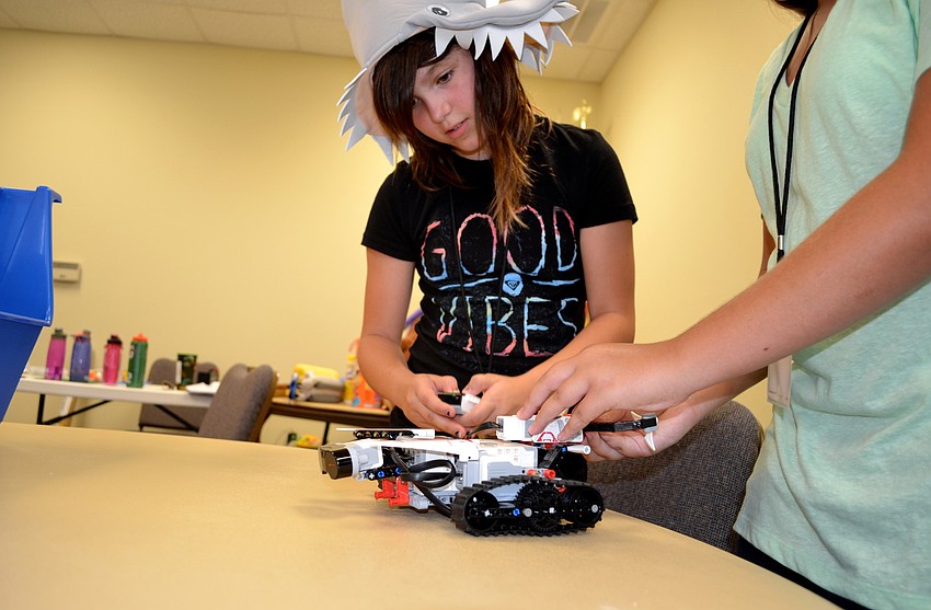 Bianca Shriver, 10, inspects her Lego Mindstorms robot with her partner, Elizabeth Englander, 12.