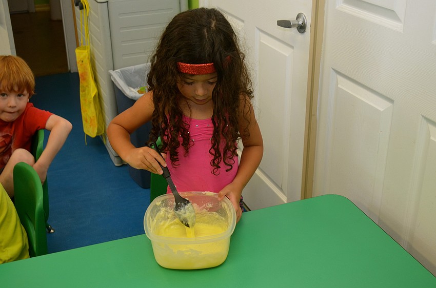 Alejandra Osorio helps make blueberry muffins.