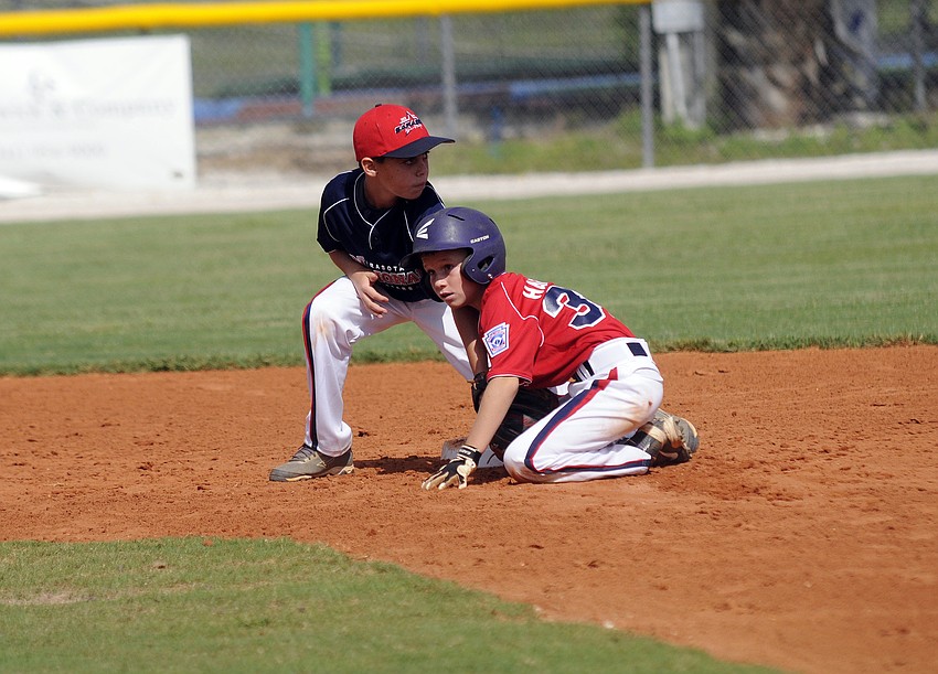 Sarasota American 9/10 All-Star Austin Harford slides safely into second base.
