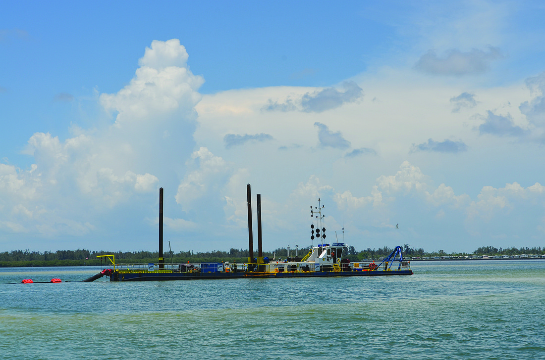 The cutter head dredge sitting just north of Jewfish Key in Sarasota Bay will pump 100,000 cubic yards of underwater sand onto Longboat Key's shore this summer. Photo by Kurt Schultheis