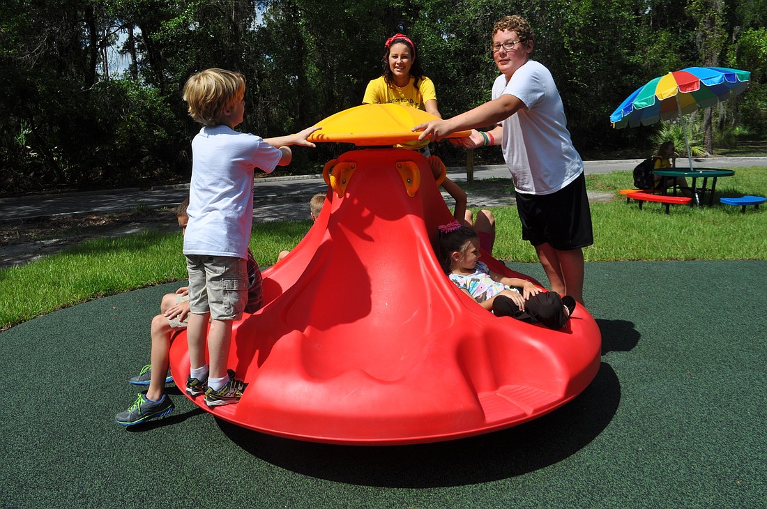 Children play on the playground before the ceremony.