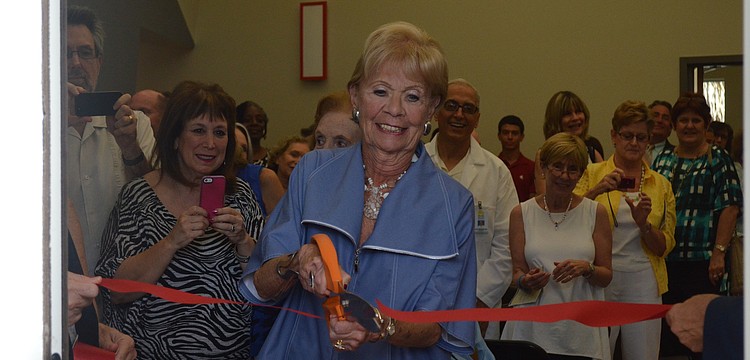Sally Shaprio cuts the ribbon of the center.