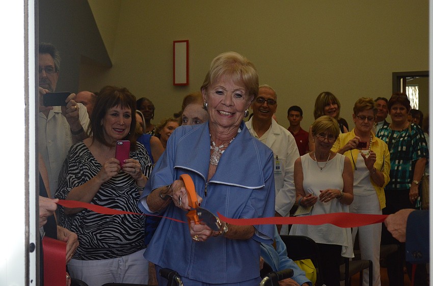 Sally Shaprio cuts the ribbon of the center.