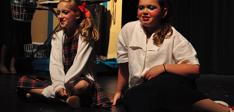 Mary Grace Epps (as Penny Pingleton) and Jordan Bollinger (as Tracy Turnblad) watch their favorite show on television.