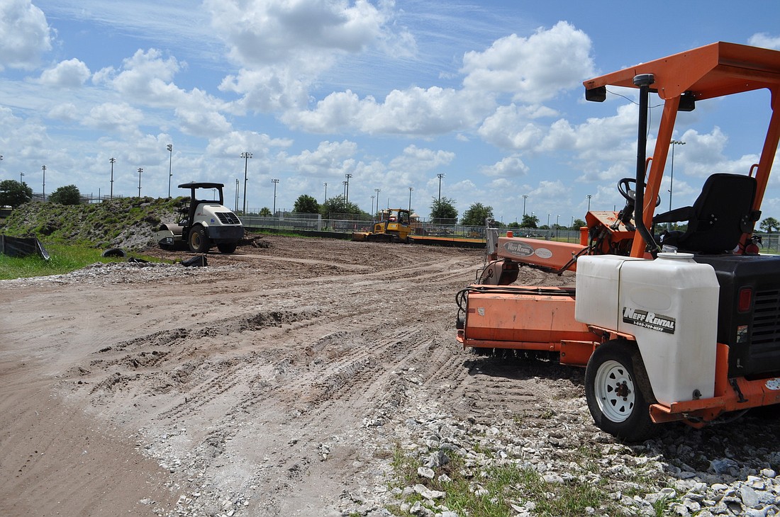 Photo by Pam Eubanks As construction continues on the addition of a second stormwater retention pond at Lakewood Ranch Park, the dirt from the pond's ditch is being used to construct an additional parking lot on Malachite Drive.