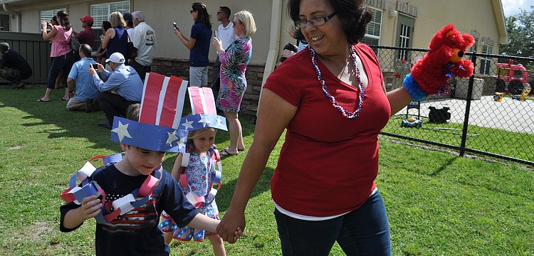 Parker Lui walks with teacher Kenia Gonzalez