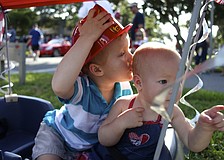 Colin Bankert, 3, kisses the head of his little sister, Giuliana, 1.
